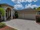 Spacious two-car garage adjacent to the main house with a brick paved drive at 13538 Thoroughbred Dr, Dade City, FL 33525