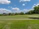 View of the lush green golf course and sunny skies at 13538 Thoroughbred Dr, Dade City, FL 33525