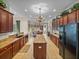Open-concept kitchen with dark wood cabinetry, granite countertops, and an island at 13538 Thoroughbred Dr, Dade City, FL 33525