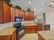 Stylish kitchen featuring granite countertops, dark wood cabinetry, and modern appliances at 13538 Thoroughbred Dr, Dade City, FL 33525