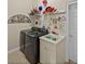 Modern laundry room with front-load washer/dryer and utility sink at 13538 Thoroughbred Dr, Dade City, FL 33525