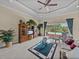 Inviting living room with pool view and a wooden entertainment center at 13538 Thoroughbred Dr, Dade City, FL 33525