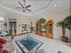 Cozy living room with a ceiling fan and view of pool at 13538 Thoroughbred Dr, Dade City, FL 33525