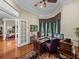 Bright office space with hardwood floors and views into other rooms at 13538 Thoroughbred Dr, Dade City, FL 33525