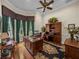 Spacious office with a large wooden desk, built-in shelving, and a ceiling fan at 13538 Thoroughbred Dr, Dade City, FL 33525