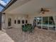 Covered patio with a dining table and chairs, ideal for outdoor dining and entertainment at 13538 Thoroughbred Dr, Dade City, FL 33525