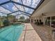 Spacious screened patio with a pool and hot tub provides the perfect setting for outdoor living at 13538 Thoroughbred Dr, Dade City, FL 33525