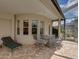 Covered patio featuring a dining table and a bar-height table with chairs at 13538 Thoroughbred Dr, Dade City, FL 33525