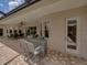 Covered patio offering a bar-height table with chairs and access to the outdoor space at 13538 Thoroughbred Dr, Dade City, FL 33525
