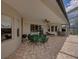 Spacious covered patio featuring a dining set and ample seating for entertaining at 13538 Thoroughbred Dr, Dade City, FL 33525