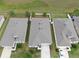Aerial view features the back of three homes with green space and a partial fence in the backyard at 13749 Hunting Creek Pl, Spring Hill, FL 34609
