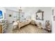 Primary bedroom with a four poster bed, ensuite bathroom, and shuttered windows at 13749 Hunting Creek Pl, Spring Hill, FL 34609