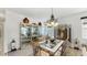 Formal dining room with glass table, decorative lighting, and elegant display cabinet at 13749 Hunting Creek Pl, Spring Hill, FL 34609