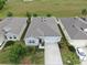 Aerial view of a well-maintained single-Gathering home with a two-car garage and tidy front yard landscaping at 13749 Hunting Creek Pl, Spring Hill, FL 34609