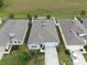 Aerial view of a single-Gathering home with tidy landscaping, a driveway, and a white fence at 13749 Hunting Creek Pl, Spring Hill, FL 34609