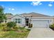 Charming single-story home with a well-manicured lawn and a two car garage during the day at 13749 Hunting Creek Pl, Spring Hill, FL 34609