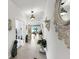 Bright hallway with decorative statues, elegant lighting, and access to the living area and bedrooms at 13749 Hunting Creek Pl, Spring Hill, FL 34609