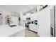 Bright kitchen featuring white cabinets, stainless steel appliances, and a kitchen island at 13749 Hunting Creek Pl, Spring Hill, FL 34609