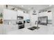 Bright and modern kitchen featuring white cabinets, stone countertops, and stainless steel appliances at 13749 Hunting Creek Pl, Spring Hill, FL 34609