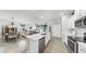 Open kitchen with stainless steel appliances, island with sink, and adjacent dining area at 13749 Hunting Creek Pl, Spring Hill, FL 34609