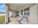 The screened patio has comfortable seating with outside views at 13749 Hunting Creek Pl, Spring Hill, FL 34609