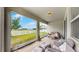 The screened patio features comfortable seating and views of the backyard at 13749 Hunting Creek Pl, Spring Hill, FL 34609