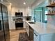 Modern kitchen featuring stainless steel appliances, white cabinets, and quartz countertops at 14019 89Th Ave, Seminole, FL 33776