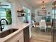 Bright kitchen with stainless steel appliances and breakfast nook with dining table and chairs at 14019 89Th Ave, Seminole, FL 33776