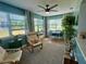 Relaxing sunroom featuring lots of natural light, comfortable seating, and dining space at 14019 89Th Ave, Seminole, FL 33776