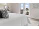 Bedroom featuring white comforter and direct access to a private balcony with black railings at 187 145Th E Ave # 4, St Petersburg, FL 33708