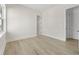 Bedroom with neutral walls, a large window, and light wood-look flooring at 187 145Th E Ave # 4, St Petersburg, FL 33708
