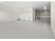 An expansive garage with speckled floor, interior stairs, and an open overhead door to the driveway at 187 145Th E Ave # 4, St Petersburg, FL 33708