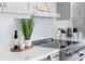 Stylish kitchen with white herringbone backsplash, stainless steel appliances, and modern decor at 187 145Th E Ave # 4, St Petersburg, FL 33708