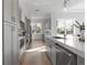Modern kitchen with stainless steel appliances, gray cabinetry, and hardwood flooring at 187 145Th E Ave # 4, St Petersburg, FL 33708