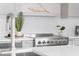 Close-up of modern kitchen featuring stainless steel range and a decorative herringbone backsplash at 187 145Th E Ave # 4, St Petersburg, FL 33708