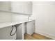 Bright laundry room features modern cabinets, countertop, sink, and wood-look tile flooring at 187 145Th E Ave # 4, St Petersburg, FL 33708