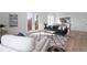 Bright living room boasts wood floors, a patterned rug, and access to the outside balcony at 187 145Th E Ave # 4, St Petersburg, FL 33708