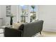 Cozy living room with modern sofa, stylish decor, and a view of the lush outdoor scenery at 187 145Th E Ave # 4, St Petersburg, FL 33708