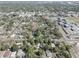 Wide aerial shot of a community with tree-lined streets, houses, and nearby commercial buildings at 2009 E Eskimo Ave, Tampa, FL 33604