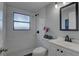Bright bathroom featuring a shower, black hardware, and a white cabinet sink at 2009 E Eskimo Ave, Tampa, FL 33604