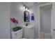 This updated bathroom has a vessel sink with black hardware and a modern light fixture at 2009 E Eskimo Ave, Tampa, FL 33604