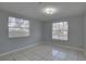 Bedroom with two windows, tile flooring, and ample natural light at 2009 E Eskimo Ave, Tampa, FL 33604