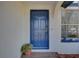 Welcoming blue front door of a home with a quaint brick landing and potted plants at 2009 E Eskimo Ave, Tampa, FL 33604