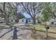 Charming single-story home with mature trees and a well-manicured front yard at 2009 E Eskimo Ave, Tampa, FL 33604