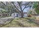 Charming home with mature trees shading the front yard and a welcoming facade at 2009 E Eskimo Ave, Tampa, FL 33604