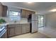 Sunlit kitchen with stainless steel refrigerator, complementing the countertops and cabinetry at 2009 E Eskimo Ave, Tampa, FL 33604