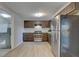 A bright kitchen with stainless steel appliances and wood-look flooring, offering a modern aesthetic at 2009 E Eskimo Ave, Tampa, FL 33604