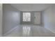 Open living space with tile flooring, a front window, and neutral walls at 2009 E Eskimo Ave, Tampa, FL 33604
