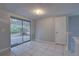 A living room with tile floors and access to a porch through sliding doors at 2009 E Eskimo Ave, Tampa, FL 33604