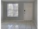 A bright room featuring a large window and light tile flooring at 2009 E Eskimo Ave, Tampa, FL 33604
